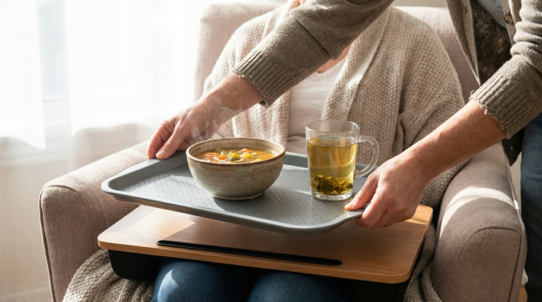 Soup and tea being brought to a patient resting comfortably at home